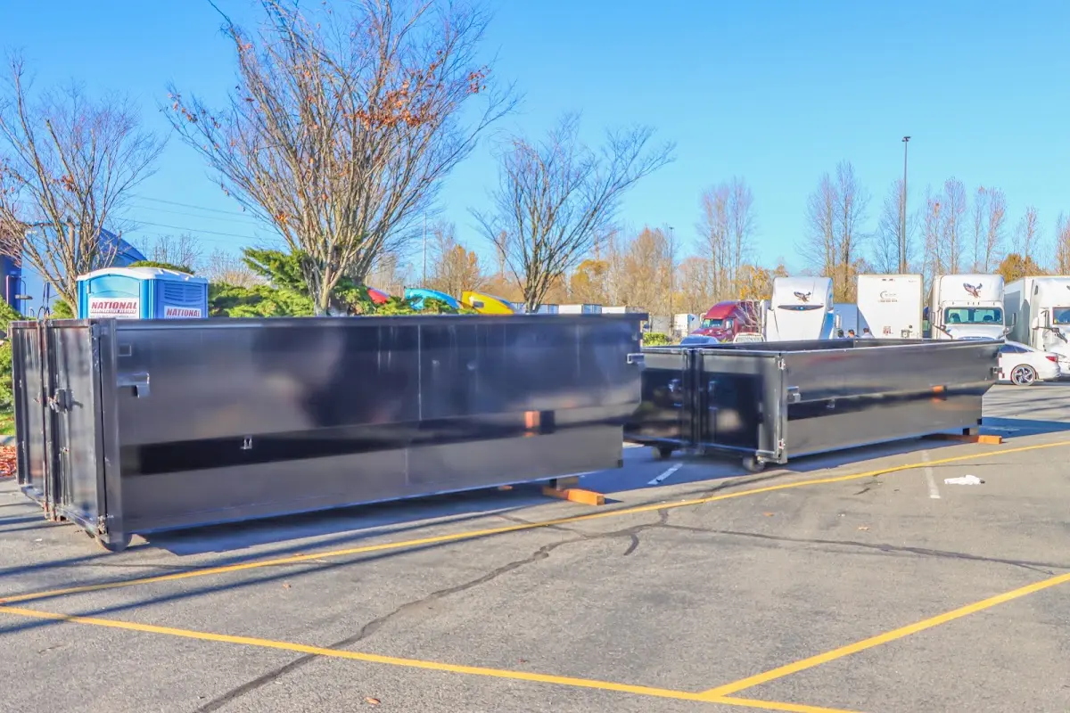 Professional dumpster rental service with roll-off container on residential driveway in Glassmanor